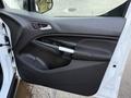 Interior side door panel of a 2017 Ford Transit Connect featuring a handle speaker and storage compartment