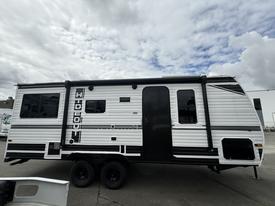 A 2022 Keystone Hideout RDWE 20RDWE travel trailer with a white exterior and black accents featuring multiple windows and a side entry door