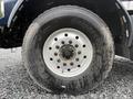 Close-up of a 2018 Kenworth T800 truck tire showing a dirty rim and visible tread patterns