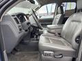Interior of a 2006 Dodge Ram 2500 featuring gray leather seats a center console and a steering wheel partially visible