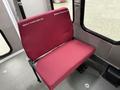 A maroon seat with company logos from Alberco Construction Ltd and Whithon Contracting Ltd inside a vehicle