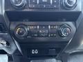 A dashboard control panel from a 2019 Ford F-550 featuring climate controls and media buttons
