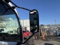 A 2014 Hino 195 truck with a side mirror visible in the foreground