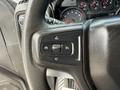 Close-up of the steering wheel controls of a 2019 Chevrolet Silverado 1500 featuring buttons for cruise control settings