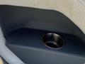 A cup holder integrated into a boat seat from a 2013 Larson 238 with a smooth surface and metallic lining