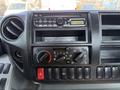 Dashboard controls of a 2012 Hino 155 featuring radio knobs air conditioning settings and various buttons