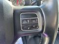 Close-up of a steering wheel control panel featuring buttons for on/off cancel and resume set in a 2014 RAM 5500 vehicle