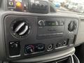 Dashboard of a 2009 Ford Econoline featuring audio controls air conditioning vents and other dashboard elements