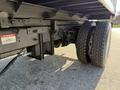 Close-up of the rear wheel and axle of a 2017 Ford F-650 Super Duty showing the large tire tread and suspension components