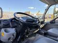 Interior view of a 2014 Hino 195 showing the steering wheel dashboard and gear shift with a focus on the driver's seat area