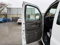 A 2021 Chevrolet Express van with an open passenger door showing the interior and door panel details