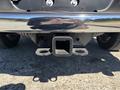 A 2015 RAM 1500 truck's rear hitch receiver with a shiny chrome bumper and visible mounting brackets