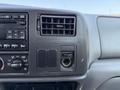 Dashboard of a 2008 Ford F-750 featuring air vents a radio control panel and a power outlet