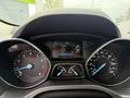 Dashboard of a 2015 Ford Escape displaying speedometer and trip information with illuminated gauges and digital readouts