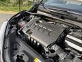 Image shows the engine bay of a 2021 Toyota C-HR with a black engine cover featuring the Toyota logo and various engine components visible