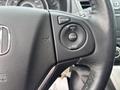 A close-up view of the steering wheel controls in a 2014 Honda CR-V featuring buttons for cruise control with options for cruise, reset, cancel, and set