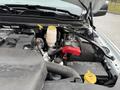 A close-up view of the engine compartment of a 2024 RAM 5500 featuring various components like the battery reservoir and cables
