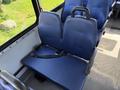 A blue two-seat bench with a seatbelt in a vehicle interior
