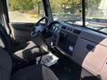 Interior of a 2020 Peterbilt 330 showing the steering wheel dashboard and seats designed for commercial use