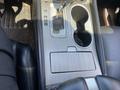 Interior console of a 2017 Nissan Murano featuring gear shift, cup holders, and a storage compartment
