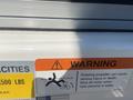 A warning label on a boat advising that the rotating propeller can cause serious injury or death and to shut off the motor near persons in water