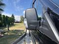 A close-up of the side mirror on a 2025 Ford Transit T-350 showcasing its sleek design and integrated light component
