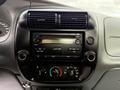 Dashboard of a 2011 Ford Ranger featuring a radio and climate control system with knobs for volume and air conditioning settings