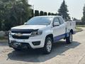 A 2017 Chevrolet Colorado with a white body and blue accents features a front winch and an open utility bed with tool compartments