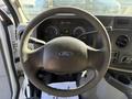 Interior view of a 2012 Ford Econoline E-450 dashboard showing the steering wheel and instrument cluster with gauges and controls