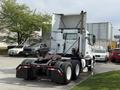 A white 2012 Volvo VNL truck is parked with its back facing the viewer showcasing its large trailer hitch and distinctive aerodynamic design