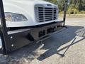 Front view of a white 2019 Freightliner M2 106 truck showing the grille and bumper with a hitch attachment
