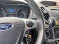 Close-up of the steering wheel and gear shift of a 2019 Ford Transit with dashboard controls and key fob visible