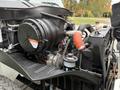 Engine compartment of a 2006 International 4200 with visible components including an air intake, hoses, and a compressor assembly