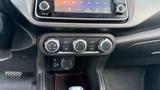 The interior dashboard of a 2019 Nissan Kicks featuring climate control dials a digital display and a USB port