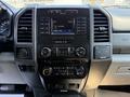 Dashboard of a 2018 Ford F-550 featuring a touchscreen display controls for radio and climate settings along with various buttons and knobs