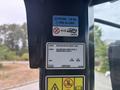 Labels and identification information on the interior panel of a 2012 Caterpillar 980 with specifications for refrigerant and safety standards