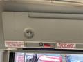 Inside view of a 2018 Chevrolet Express showing emergency release instructions with a red handle and text in English and French detailing how to open the door