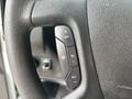 Close-up of the steering wheel controls of a 2020 Chevrolet Express featuring buttons for cruise control settings and adjustments