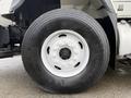 Close-up of a large tire on a 2013 International Workstar 7500 featuring a white rim and a deep tread pattern