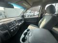 Interior view of a 2015 RAM 1500 showcasing the dashboard console front seats and cup holder