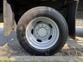 Close-up of a tire on a 2008 Ford F-450 SD featuring a silver alloy wheel and black tire with visible tread patterns