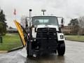 A 2016 Freightliner 108SD equipped with a snow plow attachment positioned at the front of the vehicle