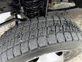 Close-up of a worn tire on a 2016 Ford F-550 Super Duty showing visible tread wear and cracks in the rubber