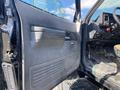 Interior door of a 1996 GMC Top Kick showing the handle and control panel