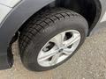 Close-up of a tire on a 2014 Ford Escape featuring a silver alloy wheel and a brand name tire with a visible tread pattern