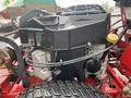 Close-up of a 2017 Ferris Rotary engine showing the black engine cover and various components including hoses and a yellow cap