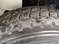 Close-up view of a weathered tire with visible tread patterns and dirt accumulation