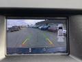 Rearview camera display showing a 2017 Ford Edge with guidelines and nearby vehicles in a parking lot setting