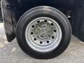 Close-up of a chrome-finished wheel with a shiny hubcap and a Toyo tire displaying the size 225/70R19.5 on a 2013 RAM 5500