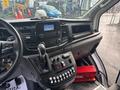 Interior view of a 2021 Ford Transit-350 showcasing the dashboard controls display screen gear shift and various buttons on the console
